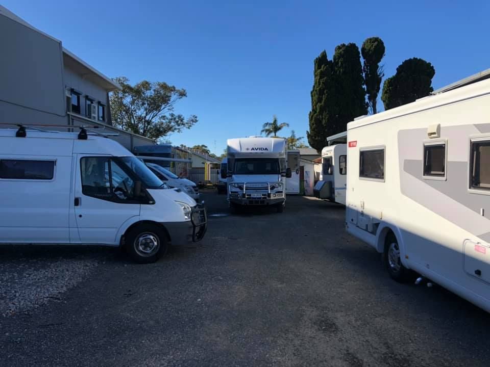 White Vans and RVs Parked in a Paved Lot — Gibbo's Auto Electrics & Air Conditioning Services in Belmont, NSW