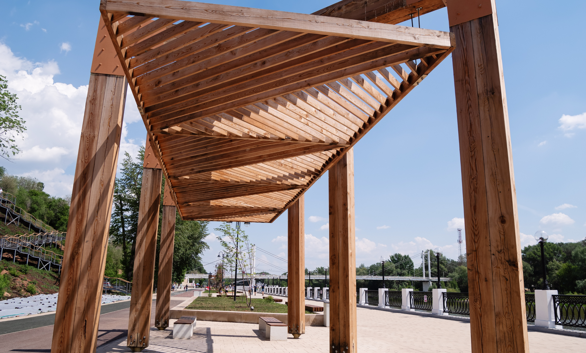 A wooden pergola with a blue sky in the background
