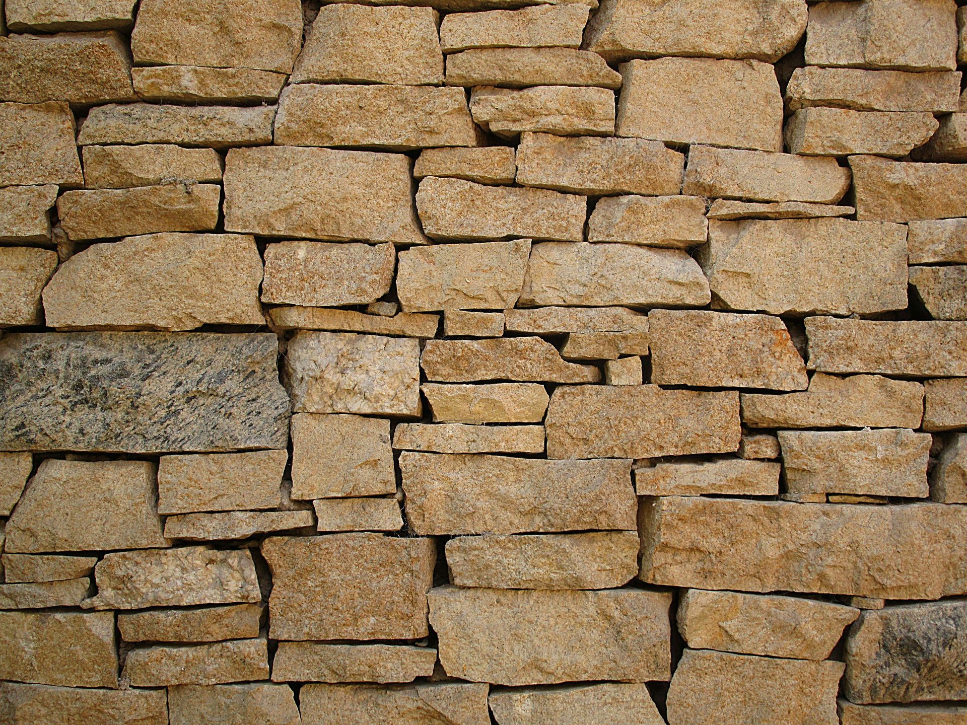 A close up of a stone wall with a lot of bricks