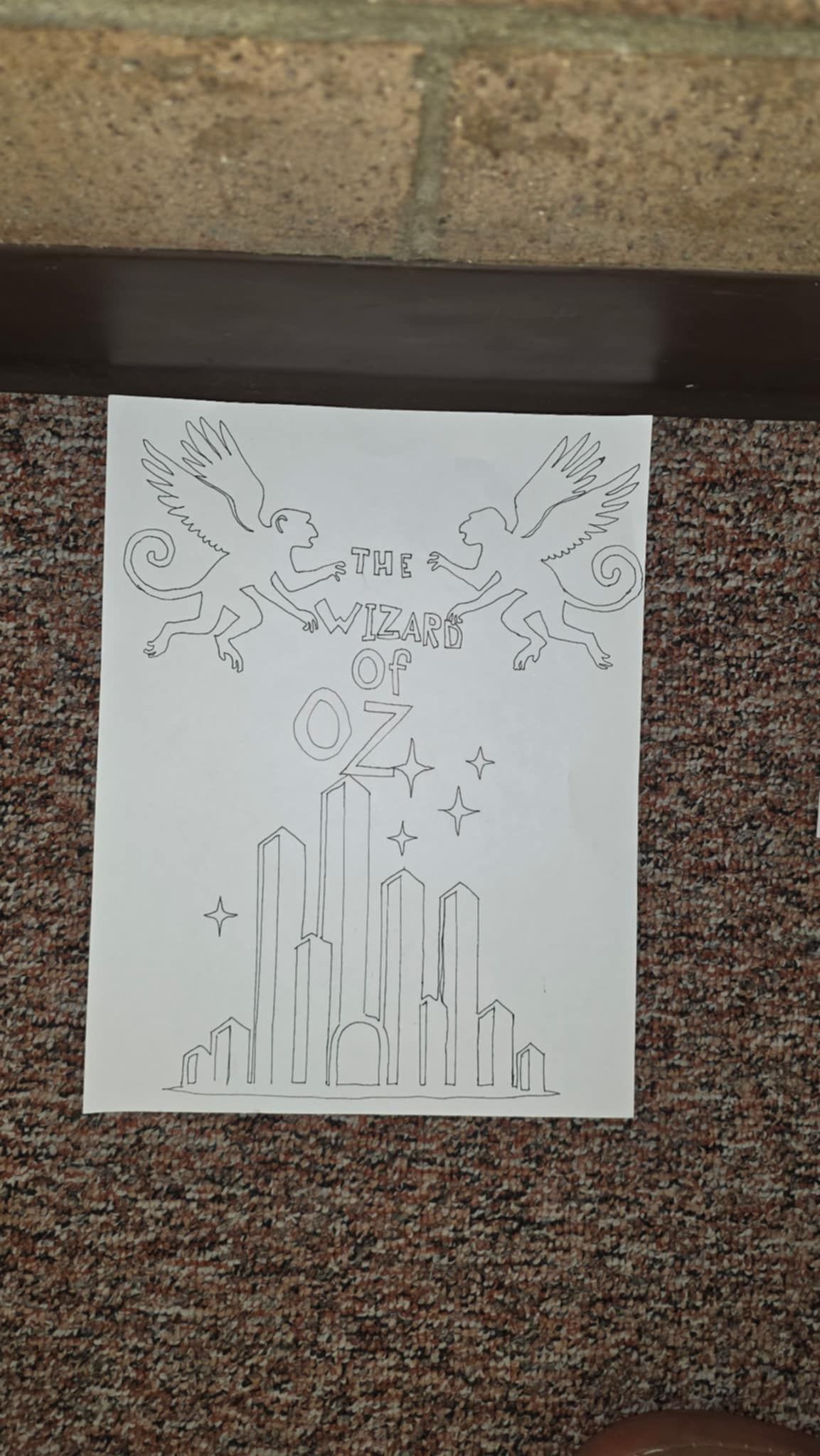 Black ink drawing of a city with tall buildings, stylized clouds, and birds in a vertical composition.