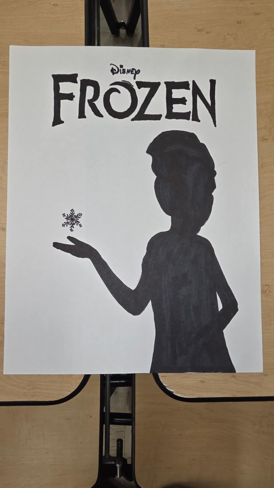 Silhouette of a person holding a snowflake. 