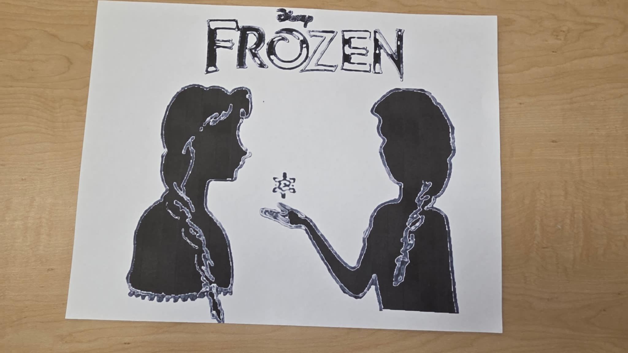 Black silhouette of Anna and Elsa from Frozen with snowflake, title above.