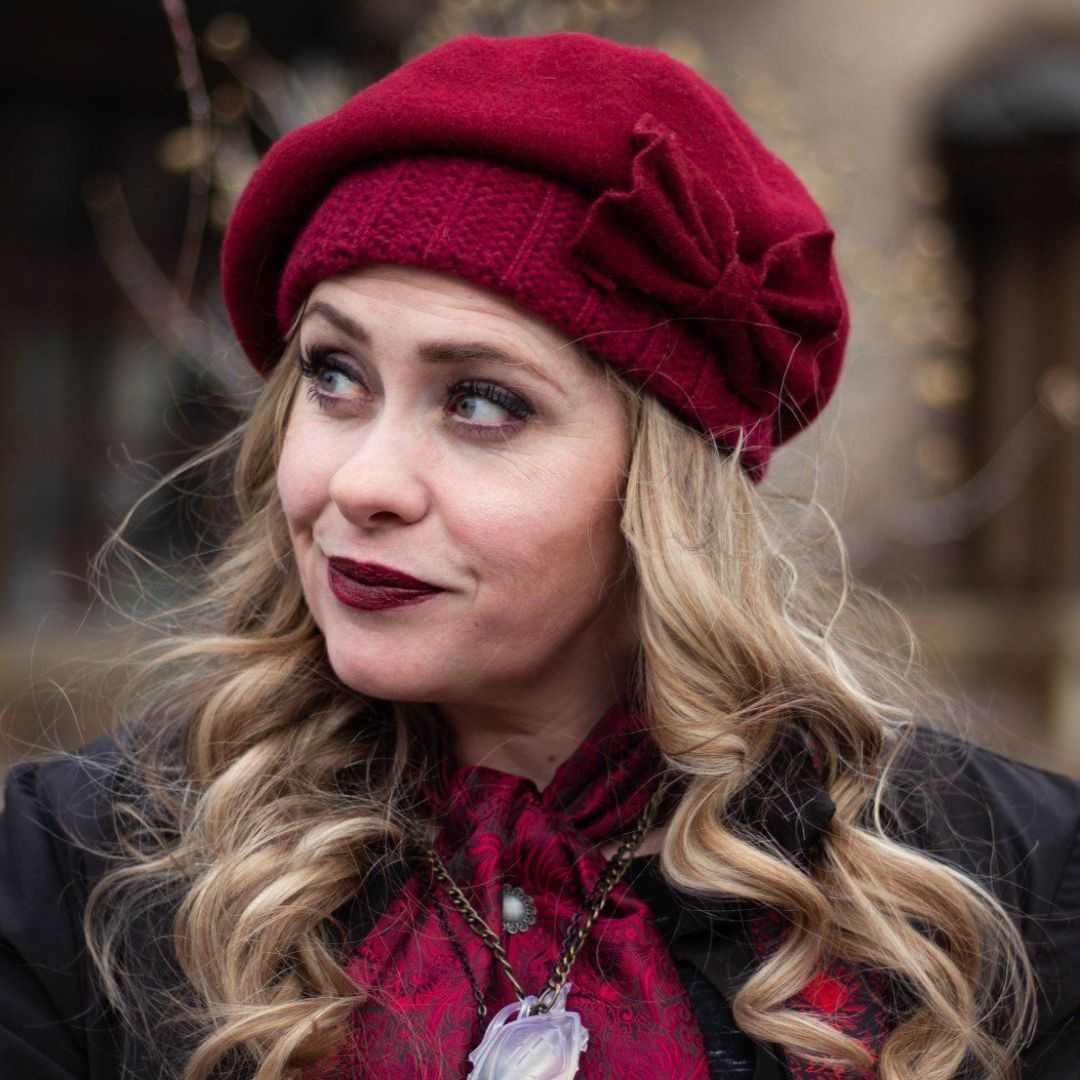 A woman wearing a red hat with a bow on it