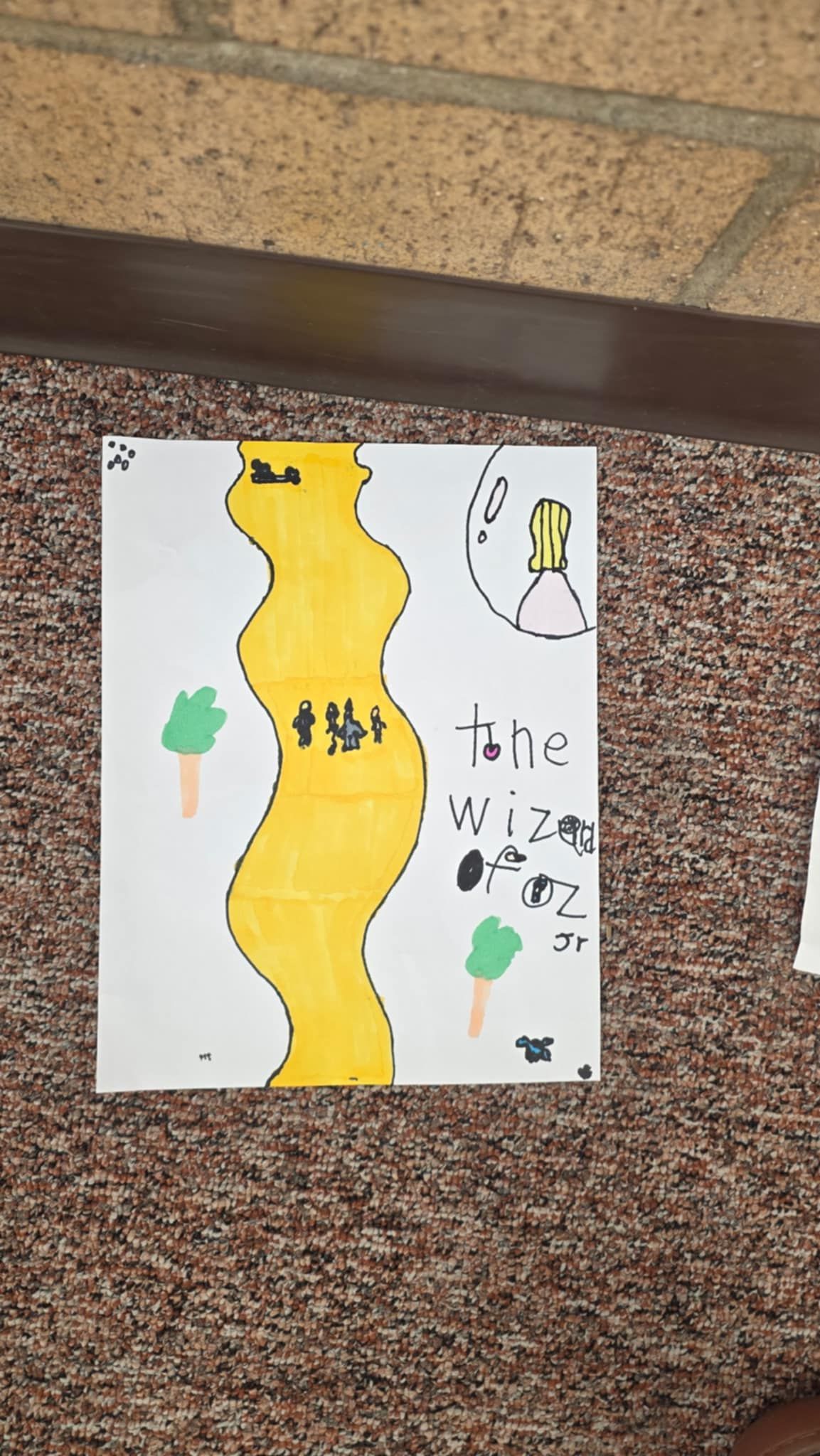 Yellow river with figures, trees. Text: