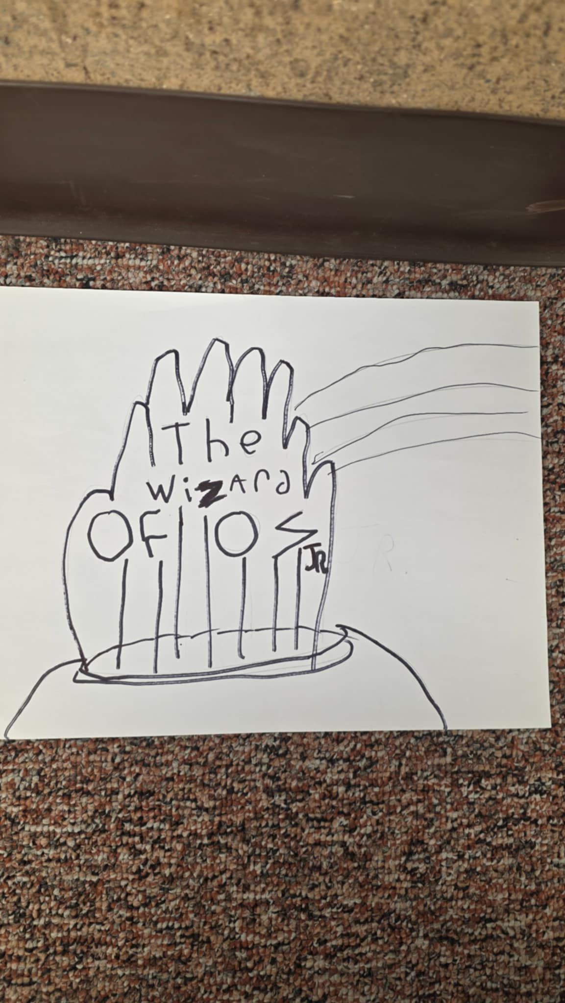 Hand-drawn art of the Wizard of Oz's head with a hand, beams of light, and the text