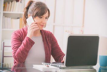 Women looking at her laptop — telephone support in Quincy, MA