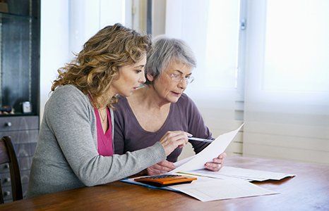 an elderly lady looking at retirement plans