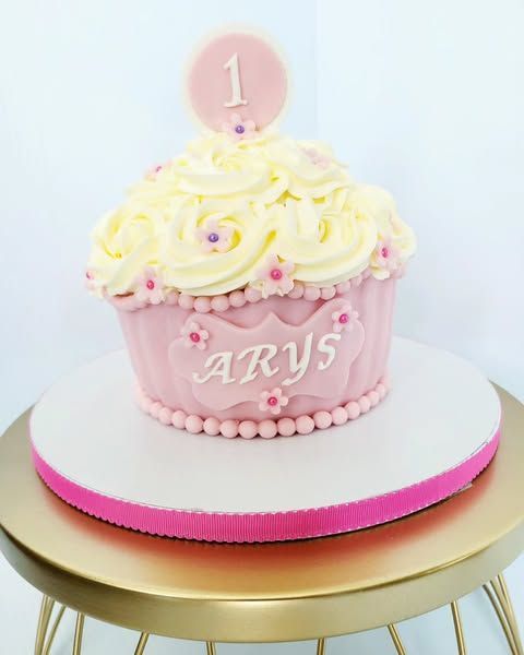 Pink and yellow cupcake cake decorated with frosting, 