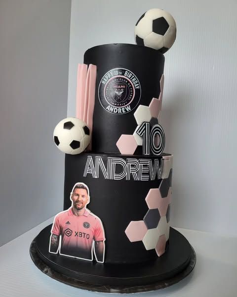 Soccer-themed birthday cake with Lionel Messi, pink accents, and a soccer ball.