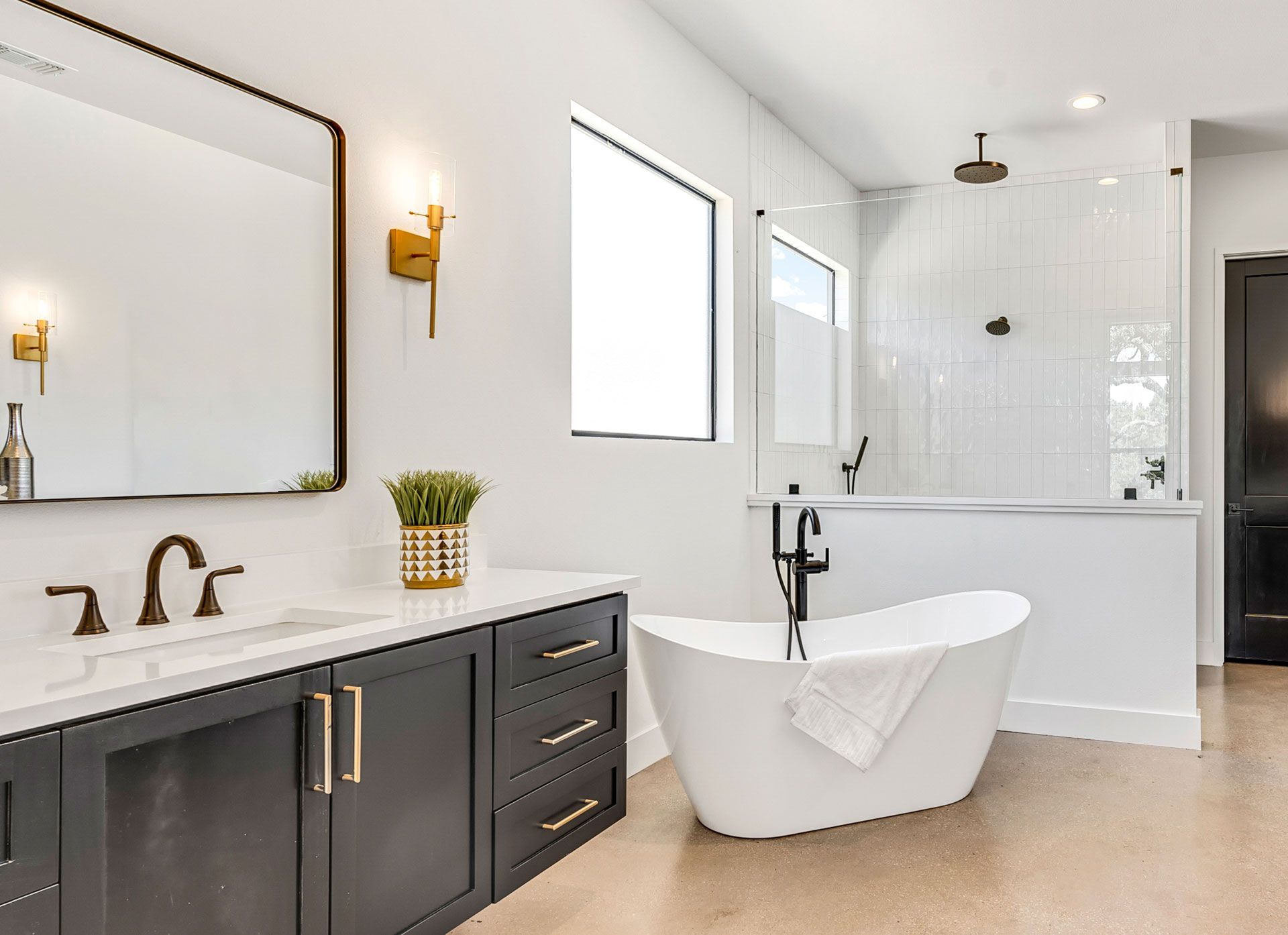 A bathroom with a bathtub , sink , mirror and shower.