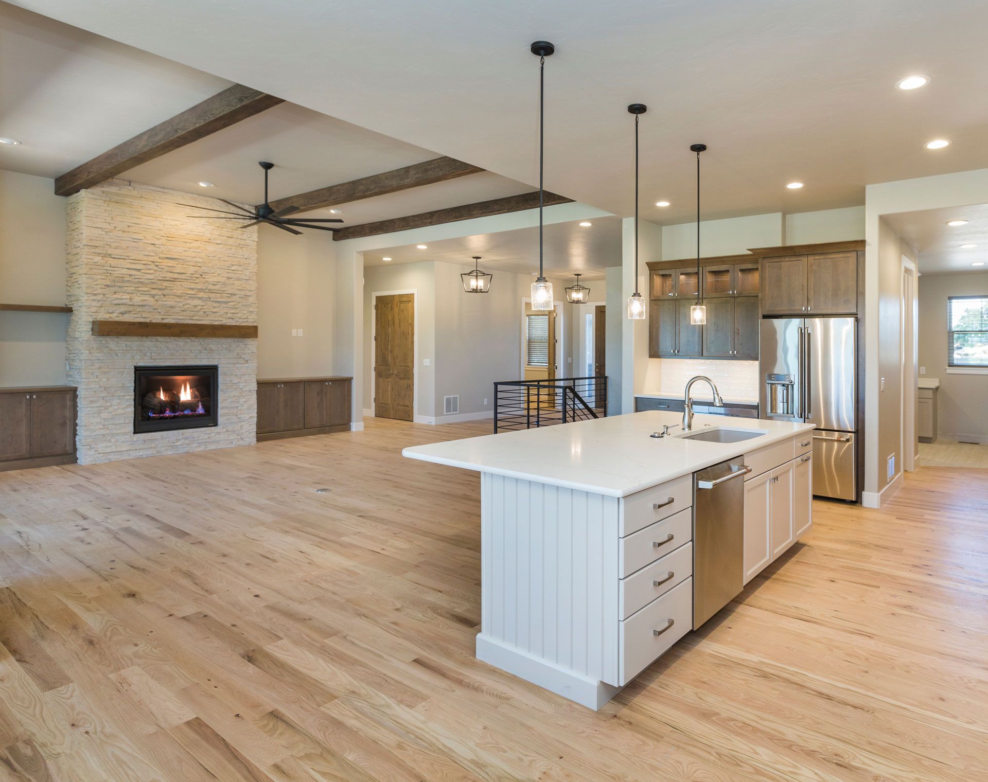 A kitchen with a large island and stainless steel appliances.