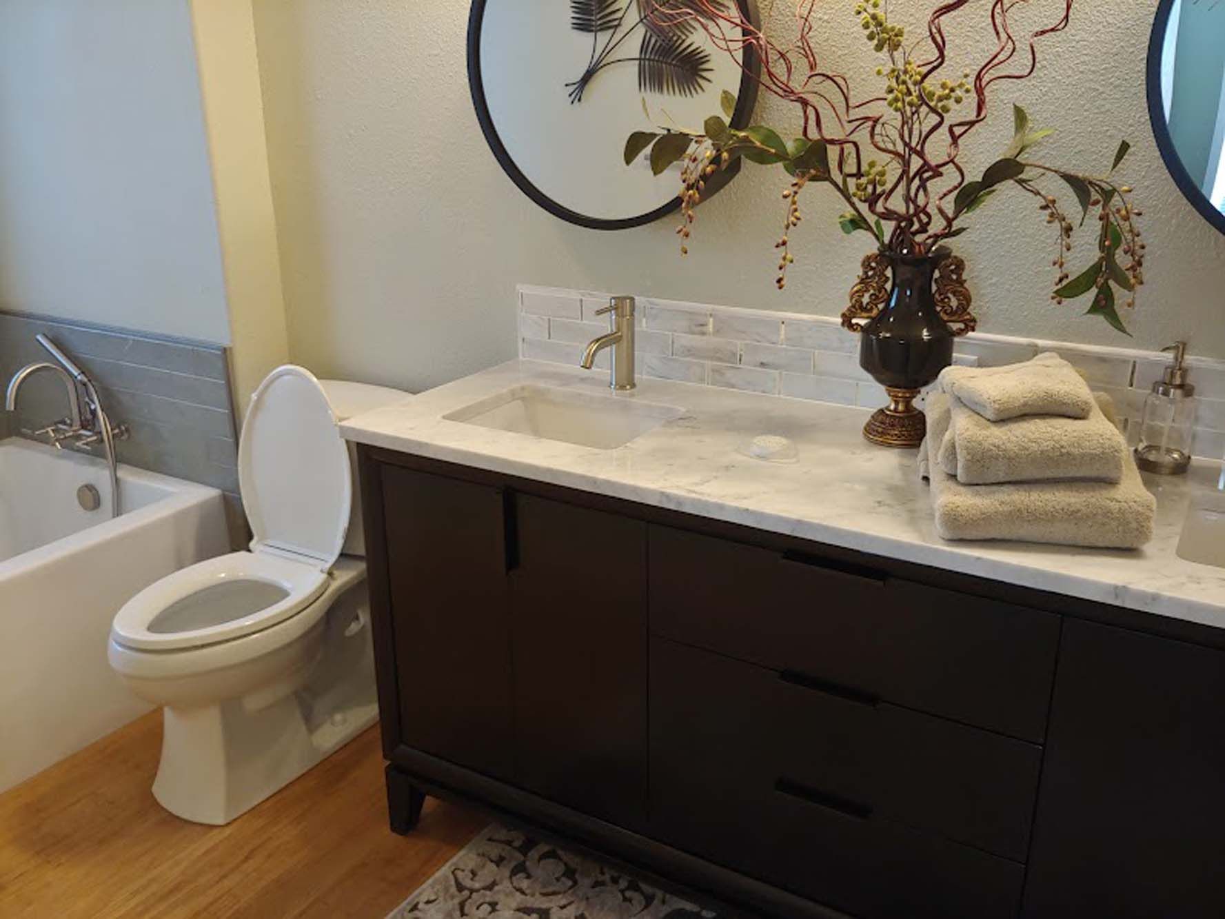 A bathroom with a toilet , sink , and bathtub.
