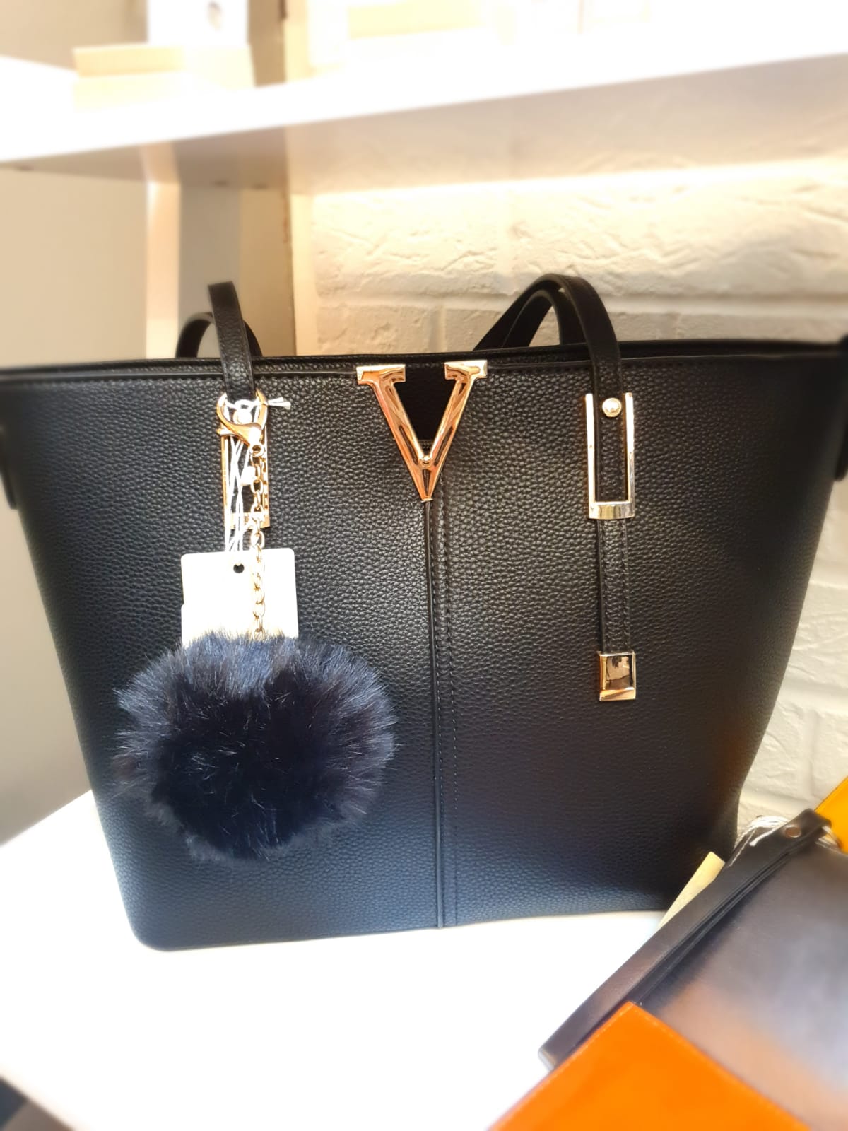 Black bag with V icon