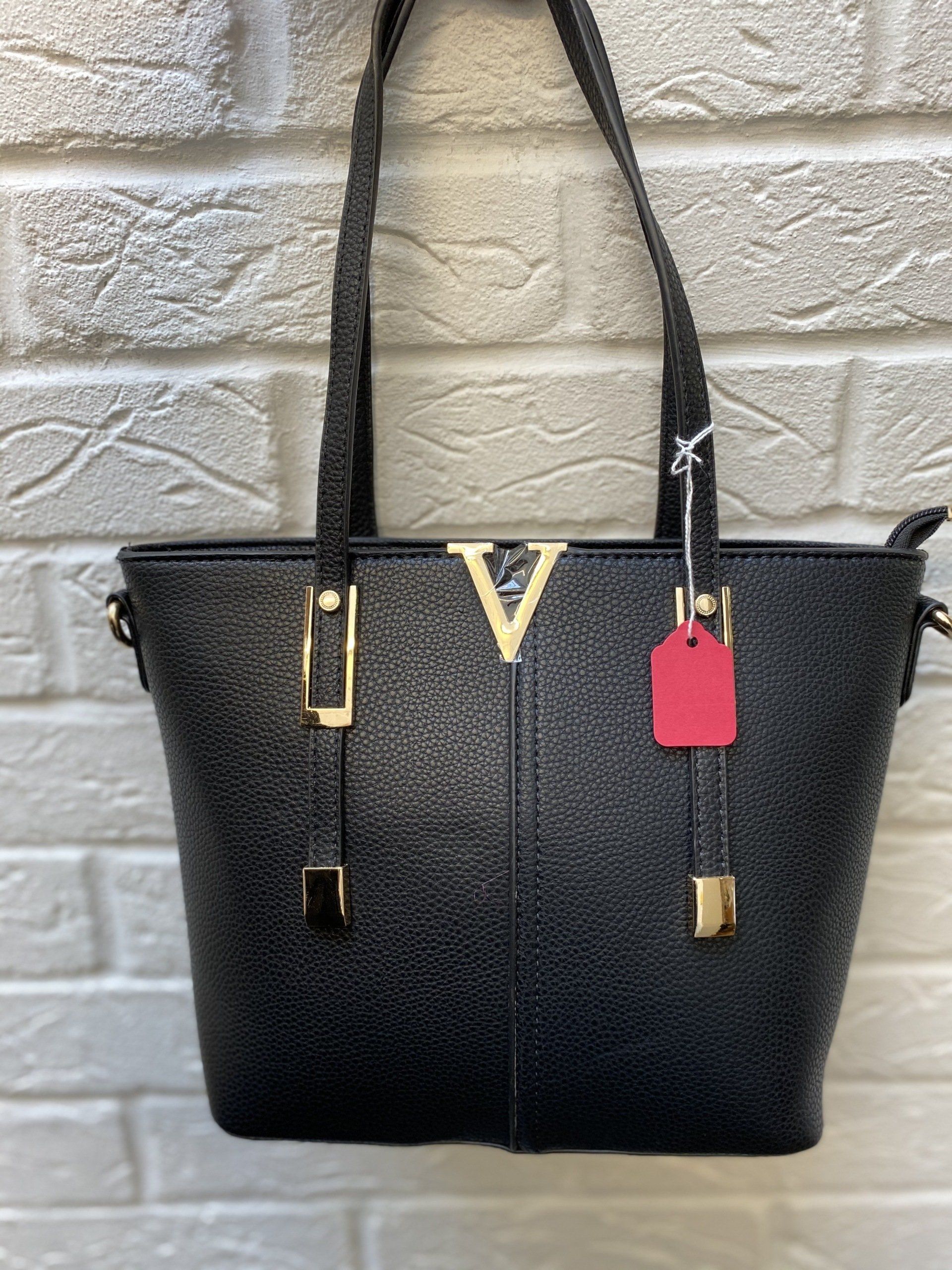 Black bag with V icon on wall