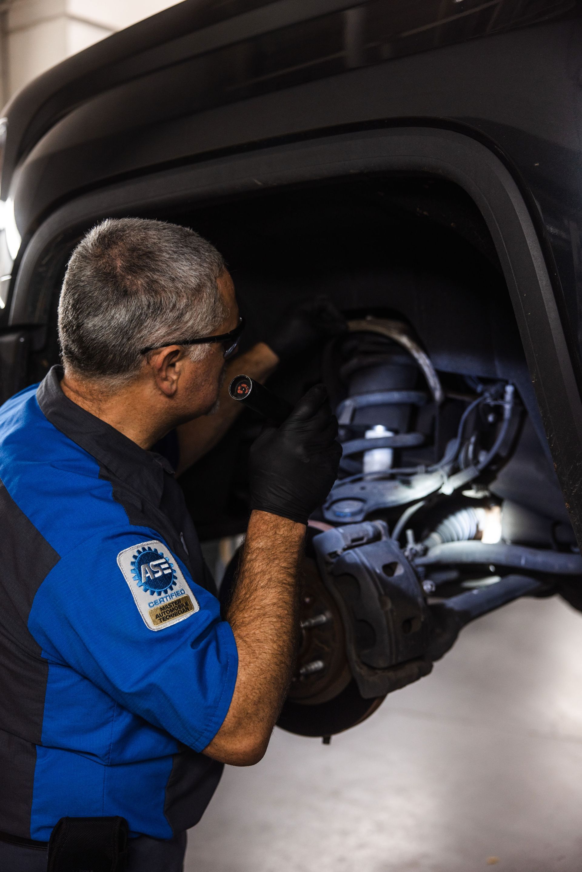 Our Certified Mechanic Checks a Vehicle's Springs in Fresno, CA - Electric Laboratories Complete Car Care