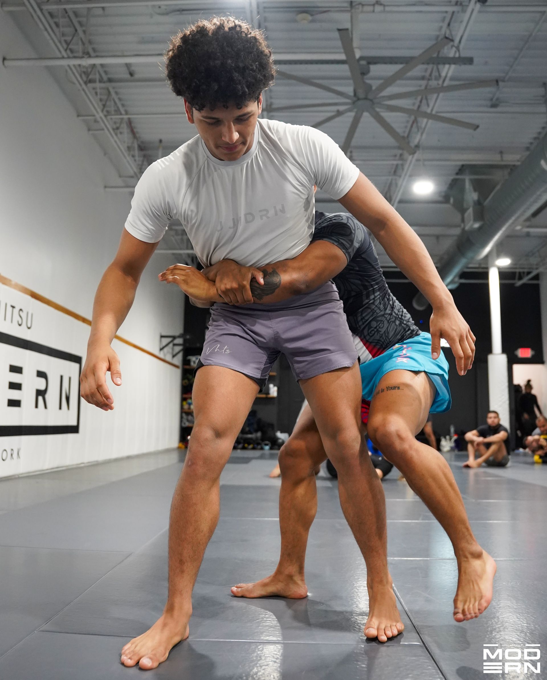 Adults practicing Brazilian Jiu-Jitsu drills at Jiu-Jitsu Modern in North Babylon, NY.
