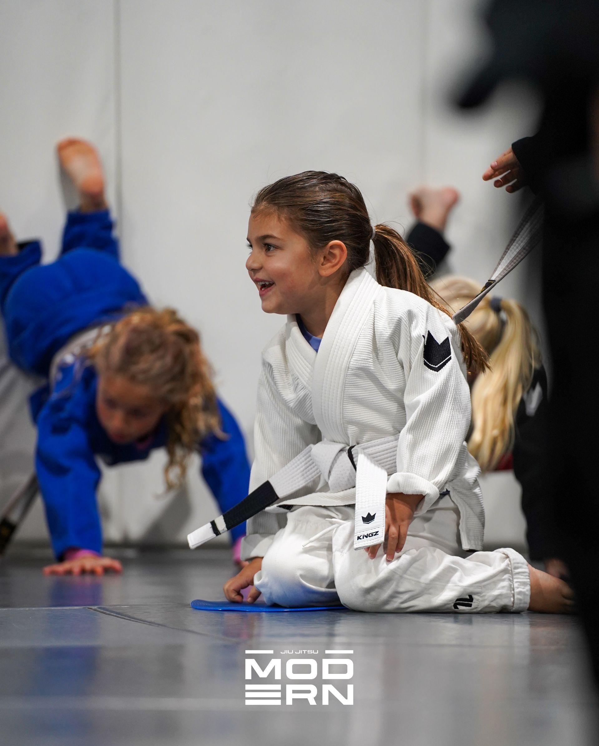 Kids practicing controlled grappling at Jiu-Jitsu Modern in North Babylon, NY to build calm focus.