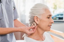 Hearing Aids —  Doctor Placing Hearing Aids to Senior Patient in Leavenworth, KS