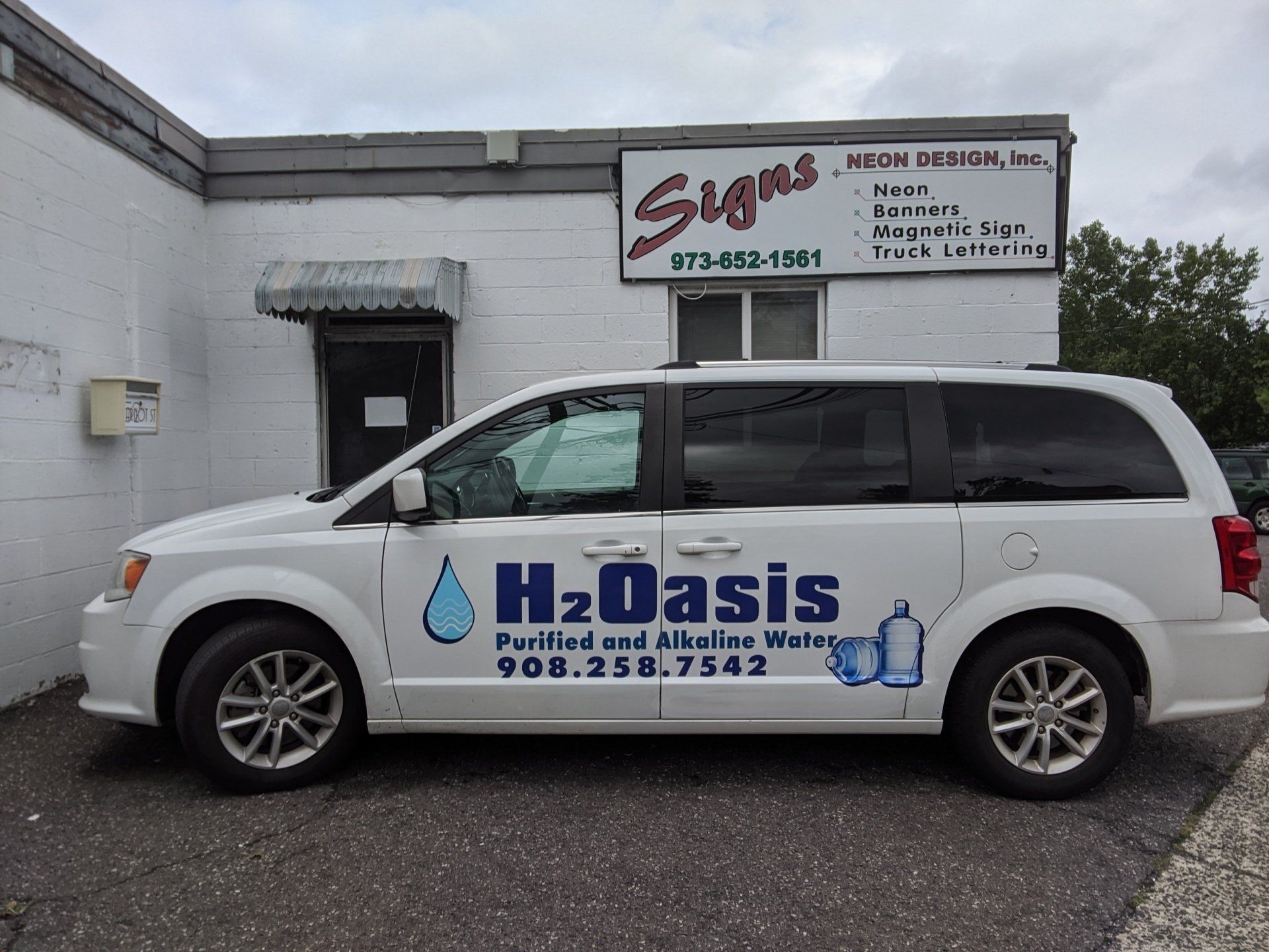 H2 Oasis Printed In The Back Of A White Van — Hillside, NJ — Sign Designer