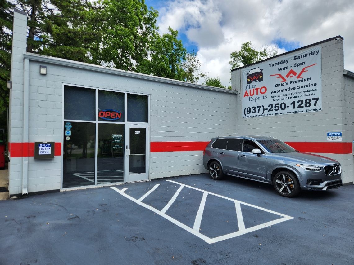 A car is parked in front of a car dealership.