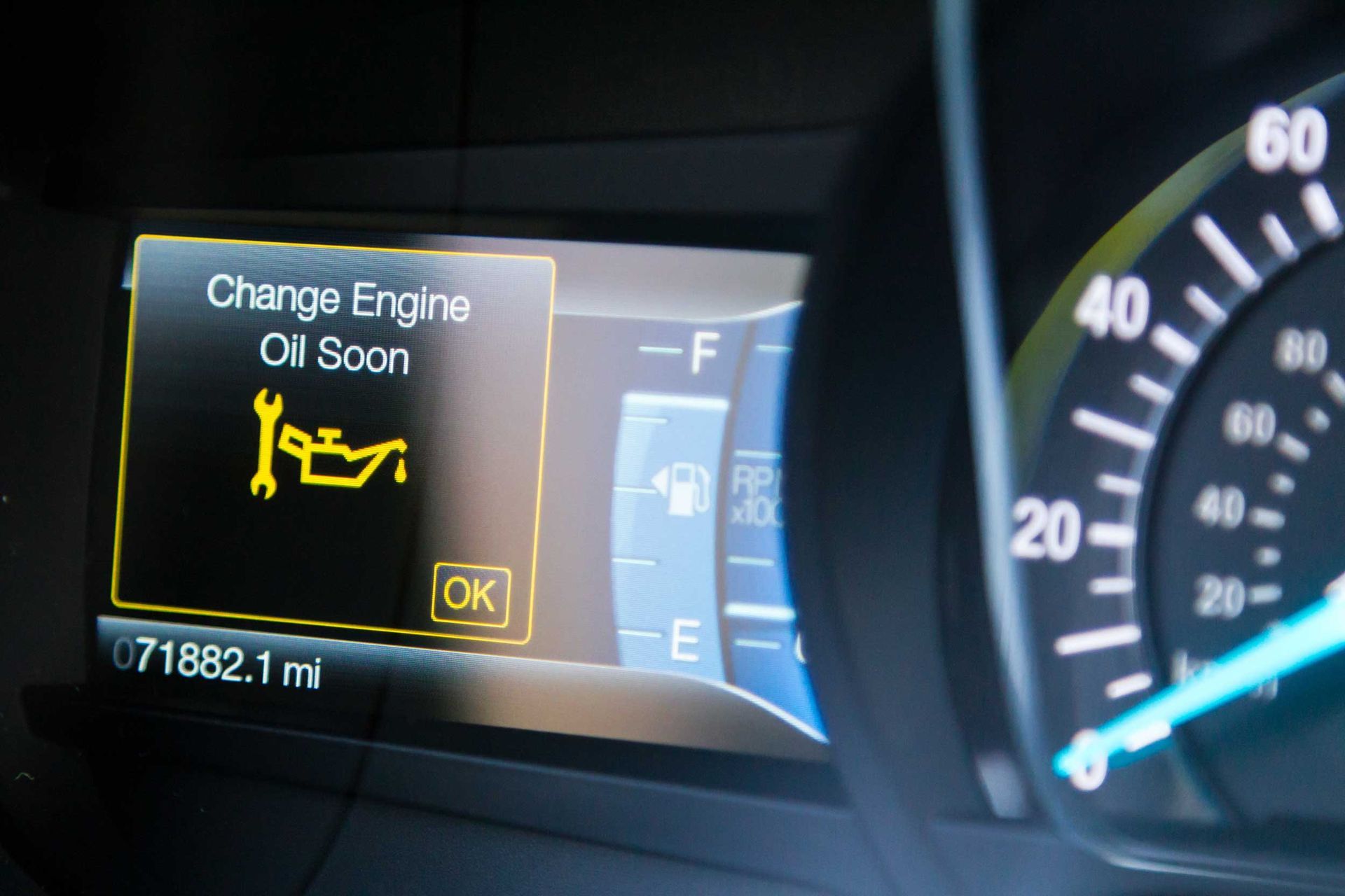 Engine oil service alert on dashboard, odometer 71,882 miles, fuel and speed gauges shown.