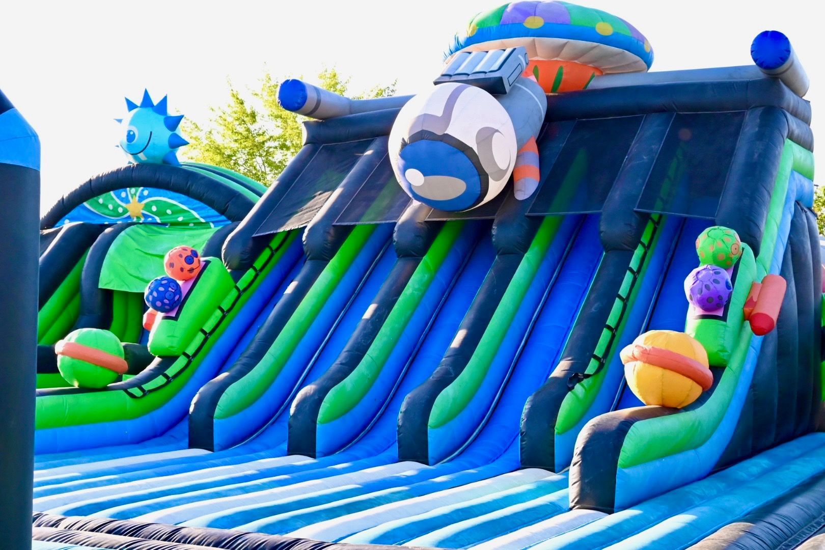 A large inflatable slide with a rocket on top of it.