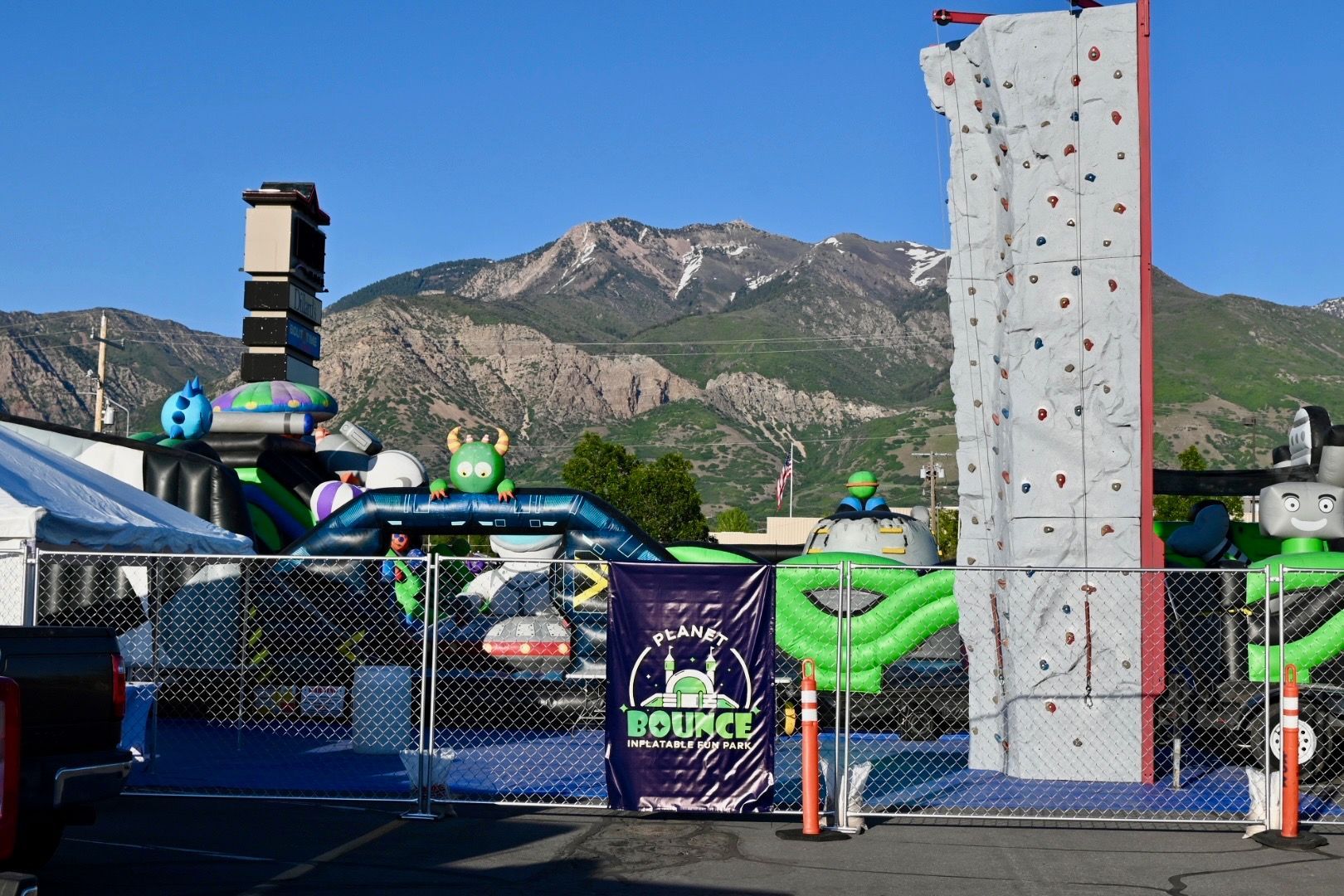 There is a climbing wall and a water slide in the background.
