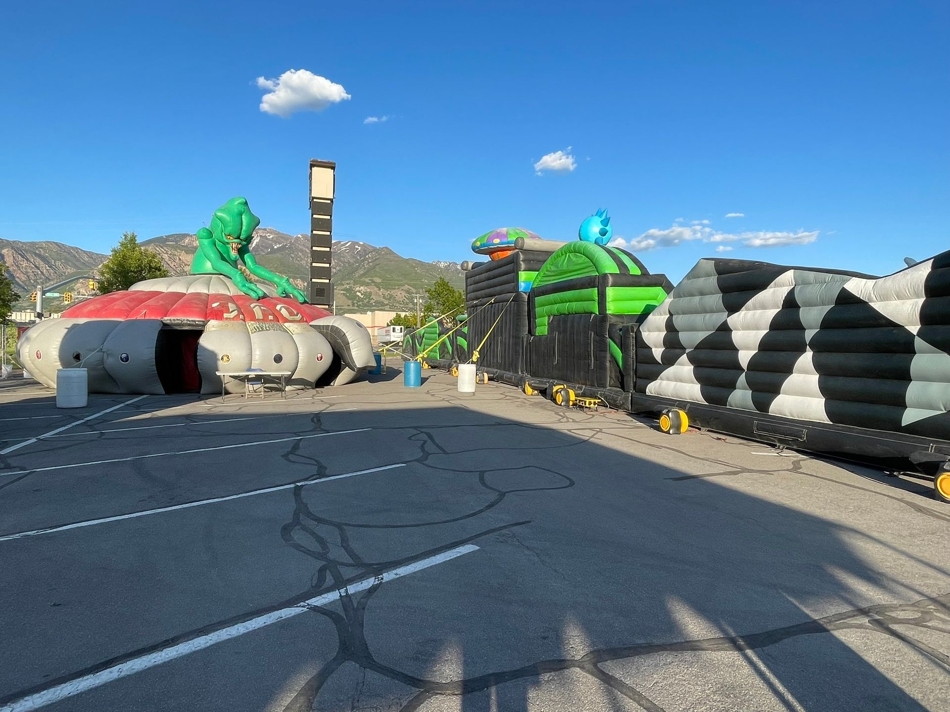 A bunch of inflatable structures are sitting on the side of a road.
