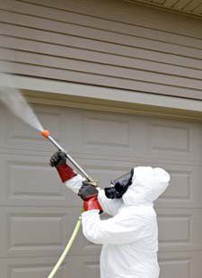 exterminator spraying a house