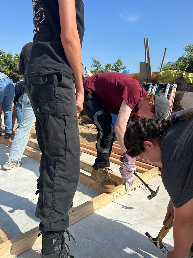 A group of people are working on a construction site.