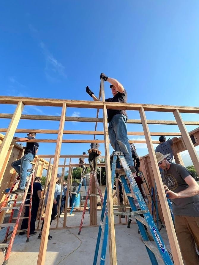 A group of people are working on a wooden structure.