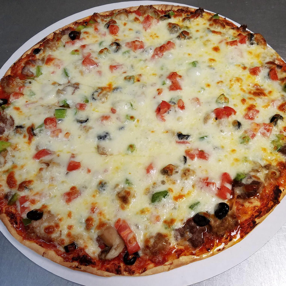 a delicious cheesy pizza with pepperonis, tomatoes, and black olives on a white plate