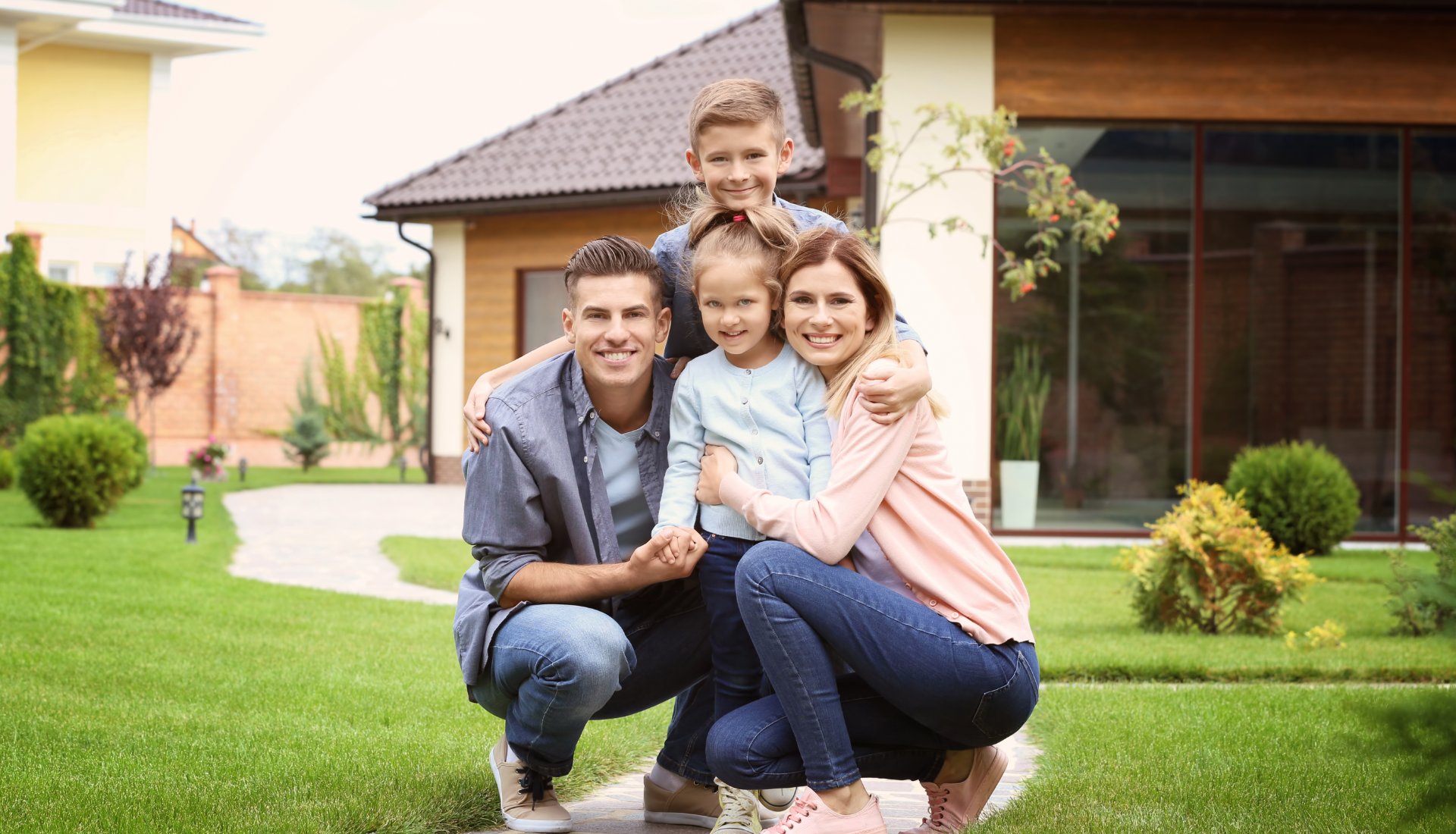 Family smiles inside a car, driving on a sunny day.