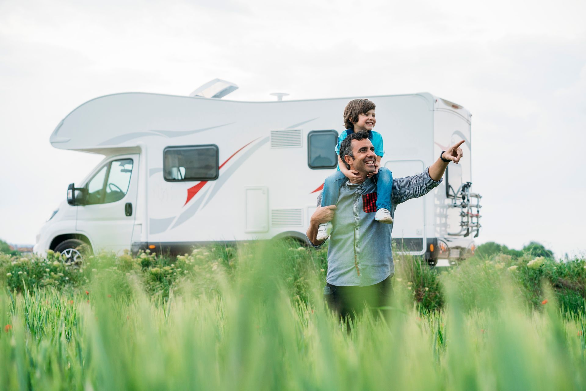 A barista taking an order from two customers at a cafe counter.