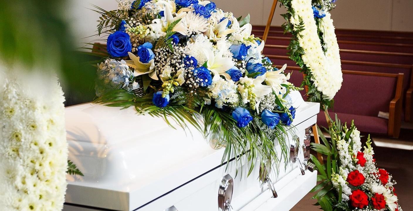 White casket with flowers