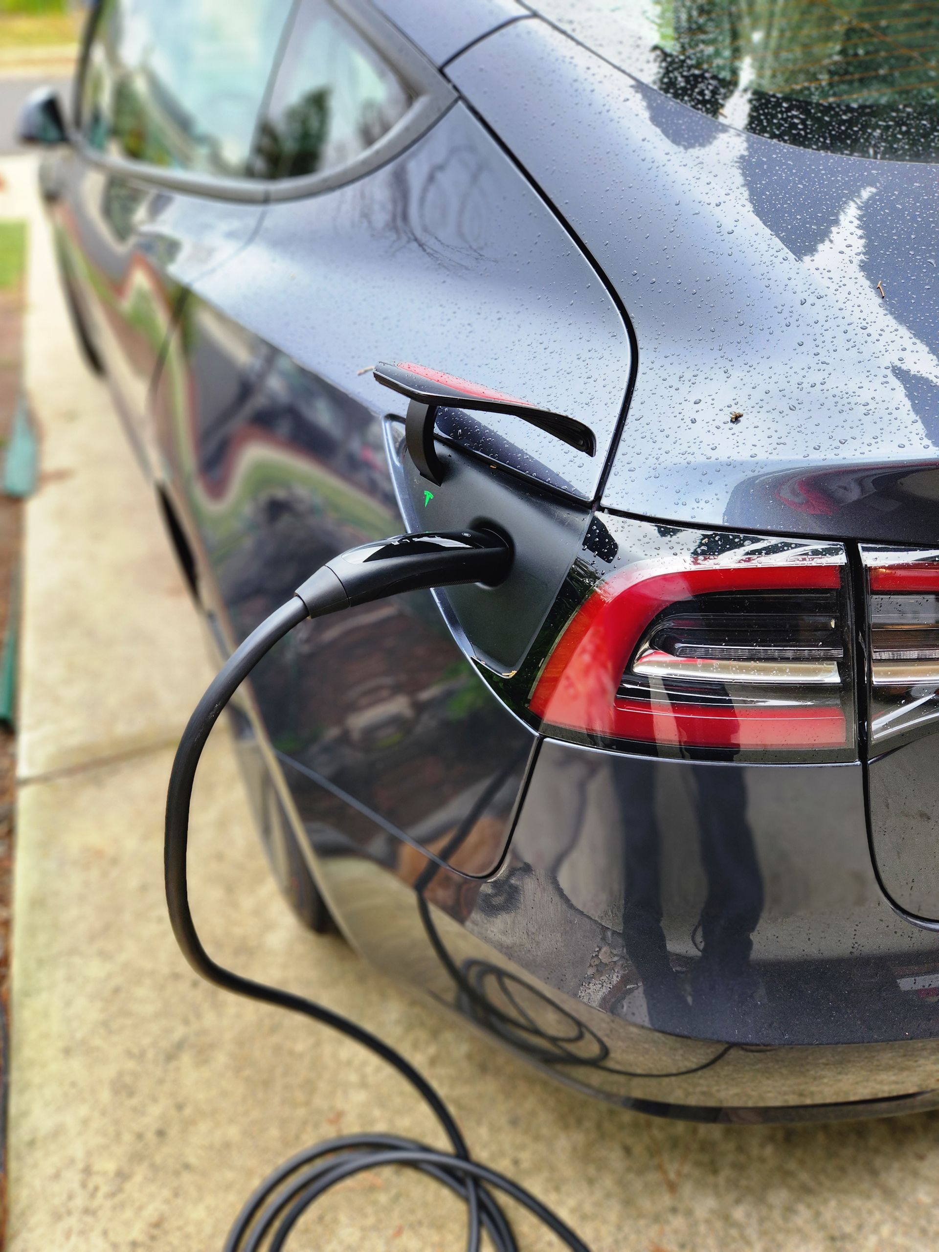 EV charger installation at home powering electric car in residential driveway
