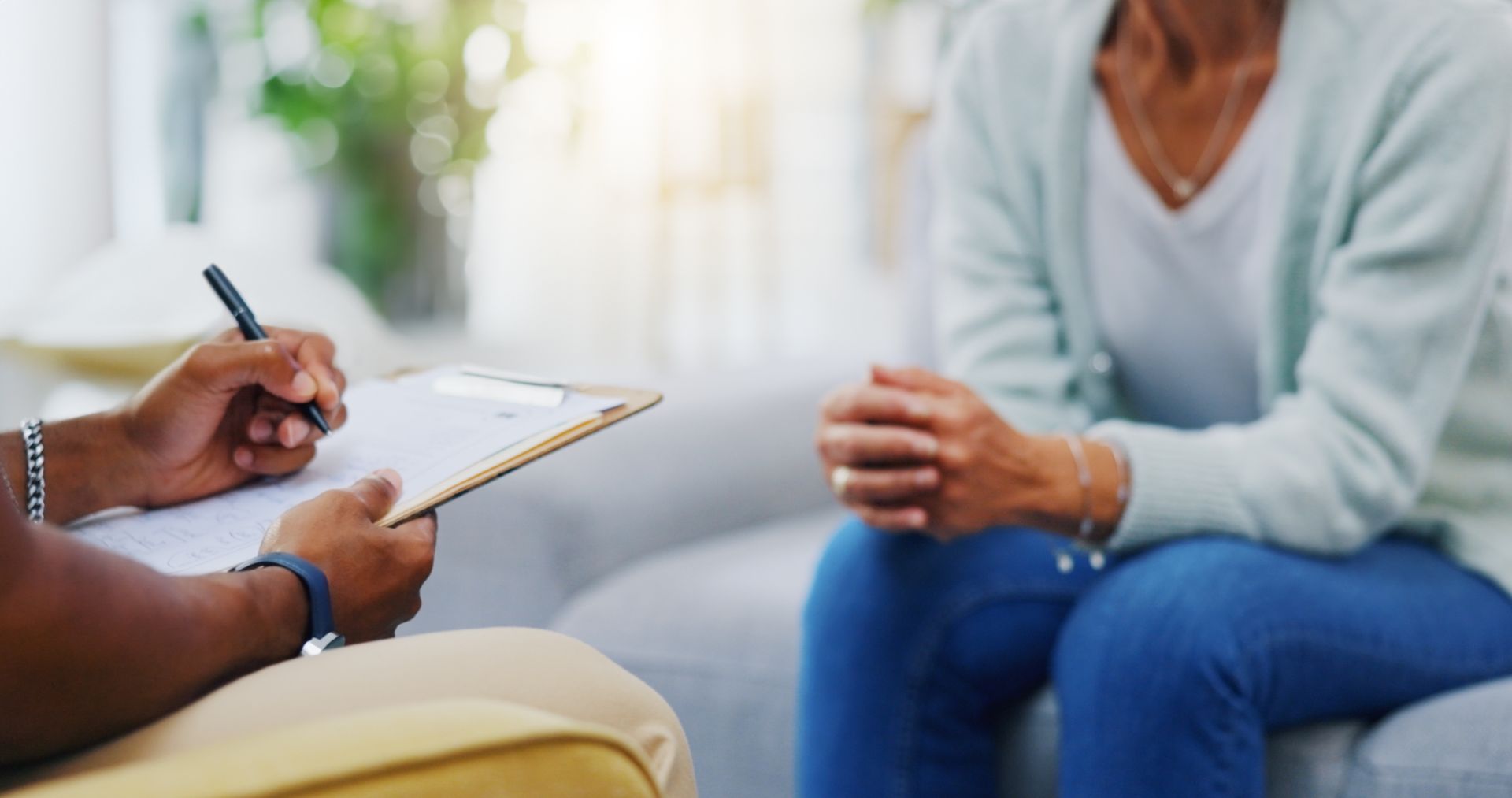 A woman is holding a clipboard and talking to another woman.