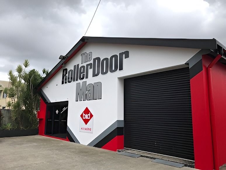 A Large White House With A Brown Garage Door — The Roller Door Man NQ In Portsmith, QLD