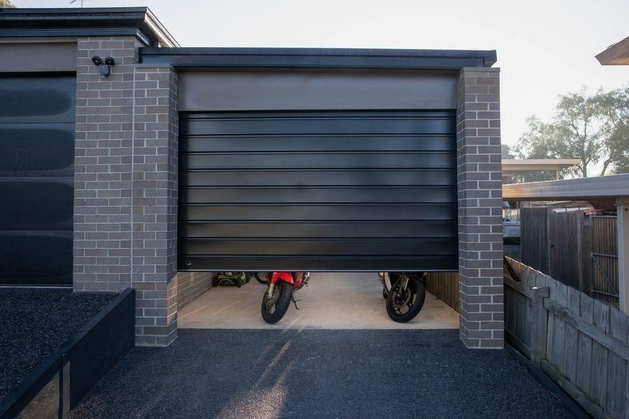 Two Motorcycles Are Parked In A Garage With The Door Open — The Roller Door Man NQ In Port Douglas, QLD