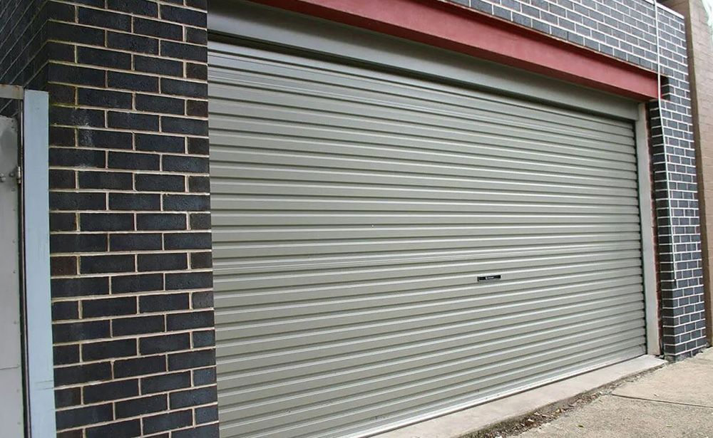 Garage with Gray Metal Roller Shutter — The Roller Door Man NQ In Portsmith, QLD