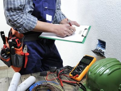 Licensed Electrician — Electrician Working In A Residential Electrical Installation in Tacoma, WA