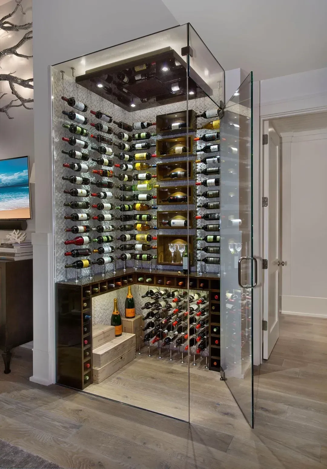 Corner wine cellar with glass walls, multiple shelves of wine bottles, and interior lighting.