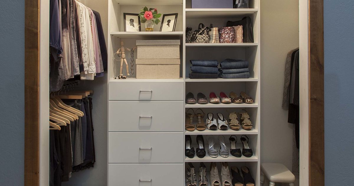 Walk-in closet organization with white shelving, drawers, shoes, clothes, and decor.