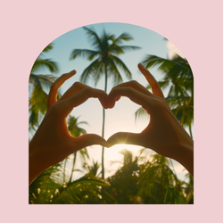 image of hands forming a heart with palm tree in background