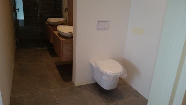 Bathroom with Toilet Bowl and Sinks — Yucca Valley, CA — John Mahany Plumbing