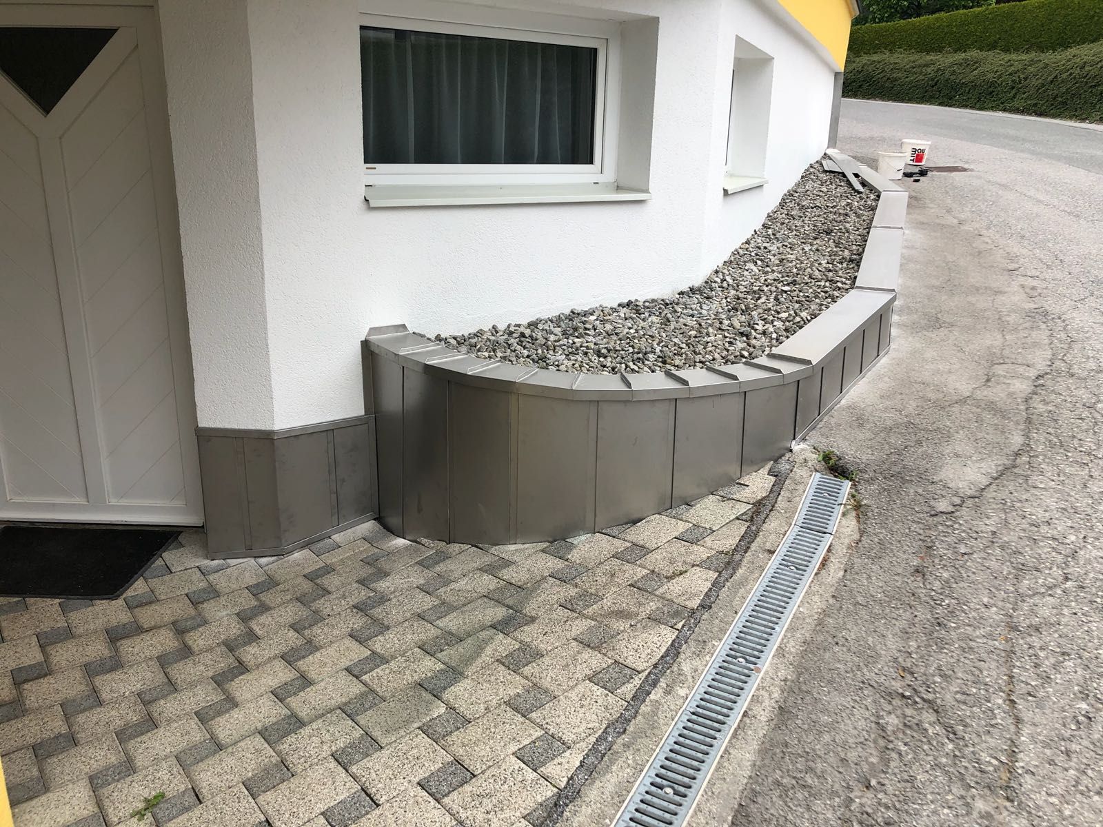 ein weißes Haus mit einem Fenster und einem Zaun