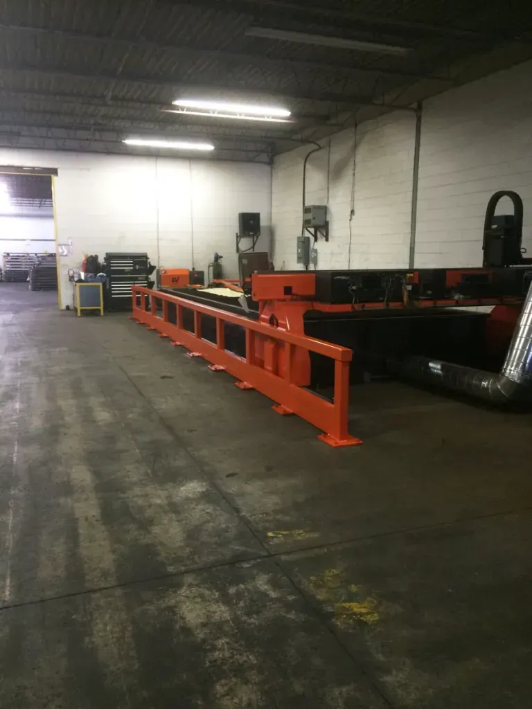 A large machine is sitting in a large warehouse.