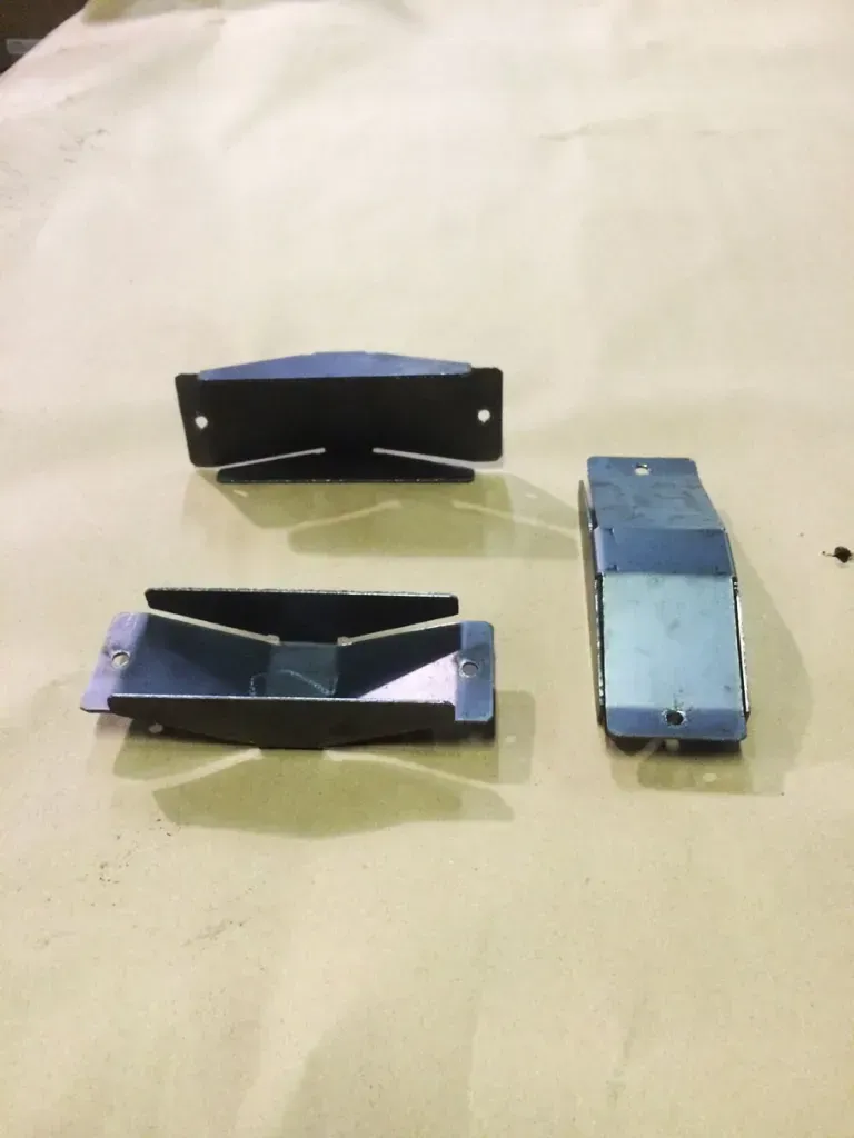 Three pieces of metal are sitting on a table