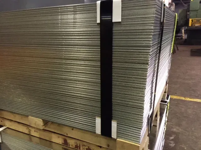 A stack of metal sheets on a wooden pallet