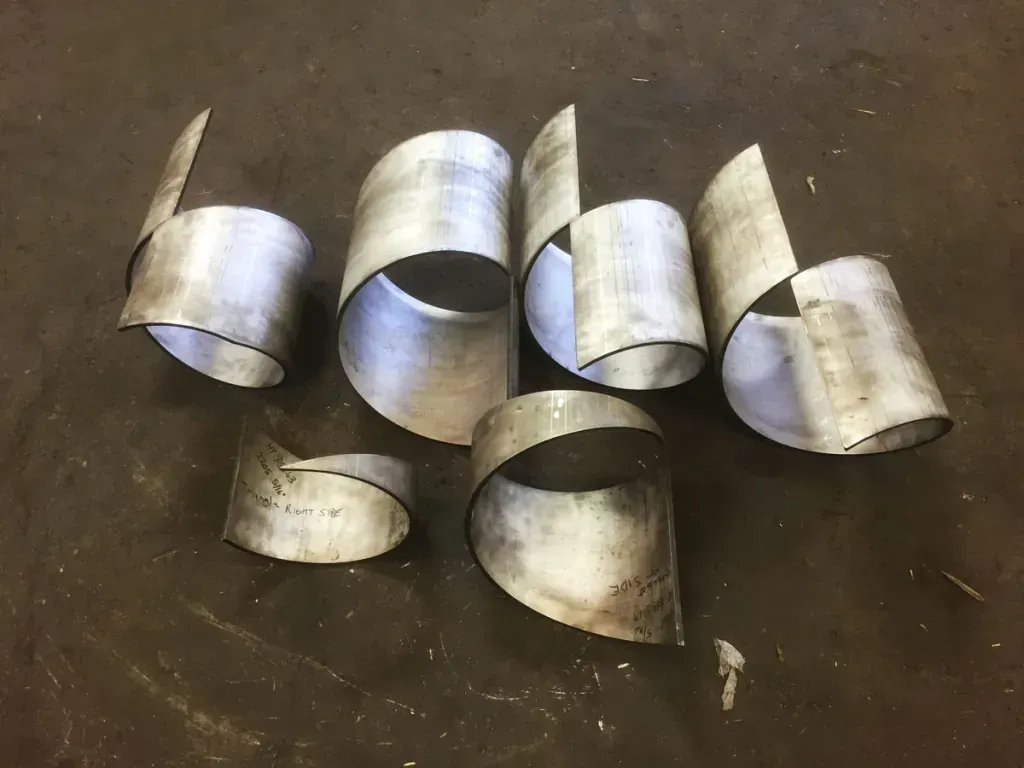 A bunch of metal tubes are sitting on a table.